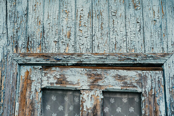 Close up outdoors shot of small windows of a wooden veranda of an old village house.