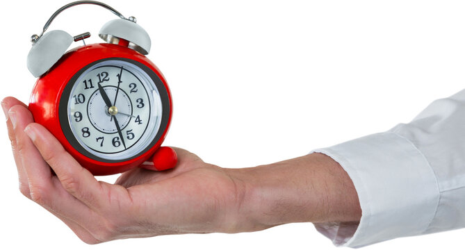 Cropped hand holding alarm clock