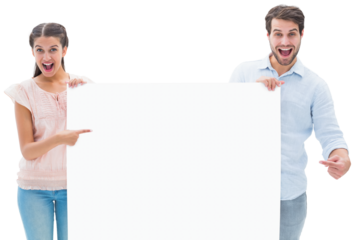 Attractive young couple smiling at camera holding poster