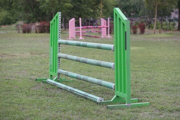 Horse obstacle course outdoors summertime. Poles in the sand at equestrian center outdoors