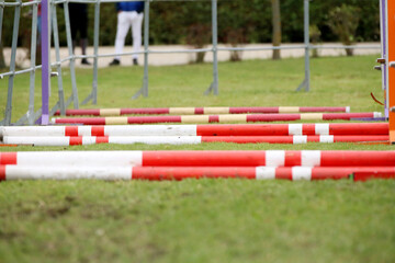 Naklejka premium Horse obstacle course outdoors summertime. Poles in the sand at equestrian center outdoors