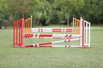 Obraz na płótnie Canvas Horse obstacle course outdoors summertime. Poles in the sand at equestrian center outdoors
