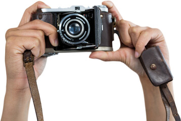 Cropped image of hands holding camera