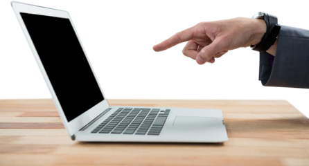 Cropped hand of businessman pointing at laptop