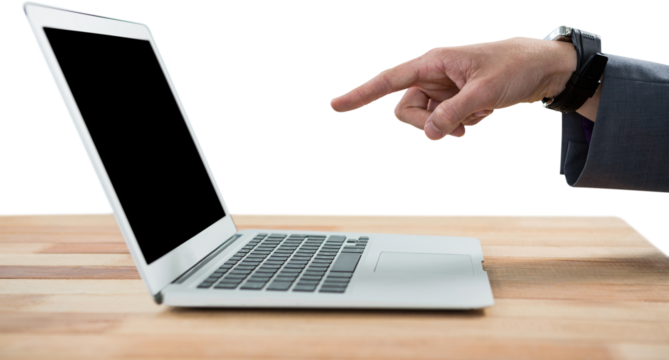 Cropped hand of businessman pointing at laptop