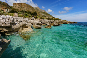 The wonderful turquoise color of the sea between the mountains and the rocky shore.