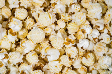 Full frame popcorn background. Popular snack for watching movies or TV.