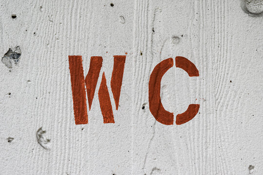 a written or informational sign in front of the door about a public toilet or wc.