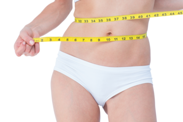 Attractive woman measuring her belly