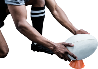 Cropped image of sportsman keeping rugby ball on kicking tee