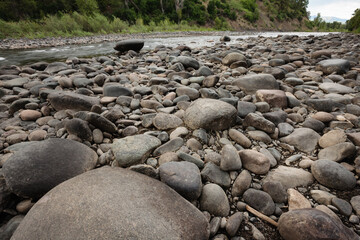 Fototapeta na wymiar The San Juan River runs easily past the river-washed rocks near Pagosa Springs, Colorado