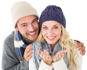 Attractive couple in winter fashion smiling at camera