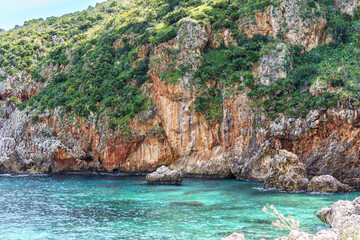 Naklejka na ściany i meble Beautiful views of the turquoise sea surrounded by huge rocky walls and mountain vegetation.