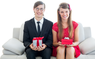 Cute geeky couple smiling and holding gift 
