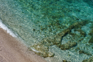 Tall rocks jutting out of the beautiful turquoise warm sea.
