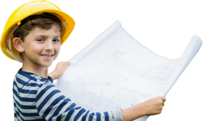 Boy in hard hat holding a plan