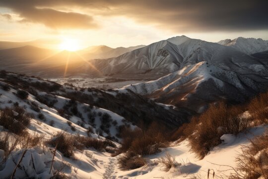 A breathtaking photography of a snow-covered mountain range at sunrise or sunset, with warm and dramatic sunlight casting long shadows over the landscape. Created with generative A.I. technology.