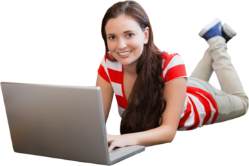 Student using laptop lying on library floor