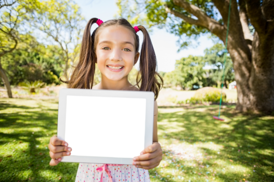 Portrait of young girl holding digital tablet - Powered by Adobe