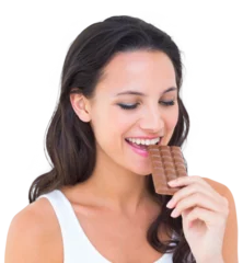 Poster Pretty brunette eating bar of chocolate © vectorfusionart