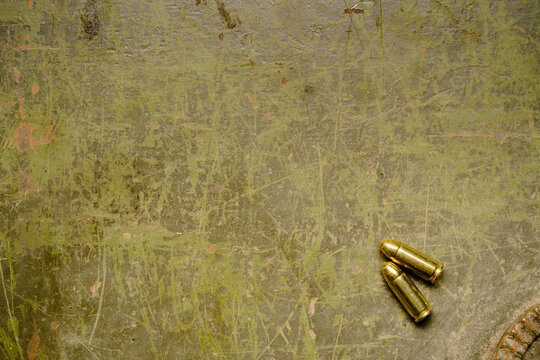 Russian military armor background with two rounds 9mm. Old Green khaki hard plate from russian tank hit by ukrainian soldiers with copy space for your text. . High quality photo