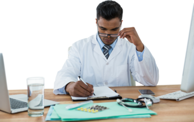 Doctor writing on clipboard at desk