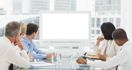 Business people looking at blank whiteboard in conference room
