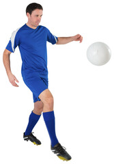 Football player in blue kicking