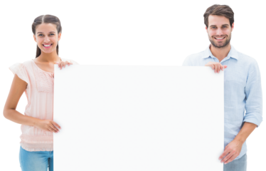 Attractive young couple smiling at camera holding poster