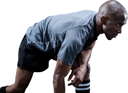 Determined sportsman bending while playing rugby