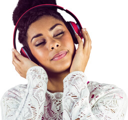 Young woman with eyes closed listening music through headphones