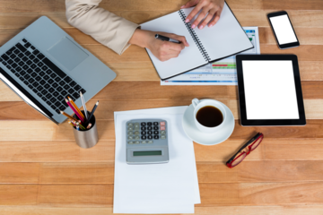 Businesswoman writing on diary