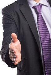 Midsection of businessman offering handshake