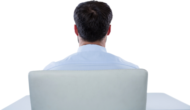 Rear view of businessman sitting on office chair - Powered by Adobe
