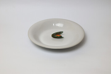 Green Mussel on plate isolated on white background, Fresh New Zealand Mussel or Perna Canaliculus on White Background.