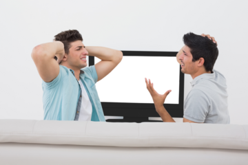 Disappointed soccer fans watching tv