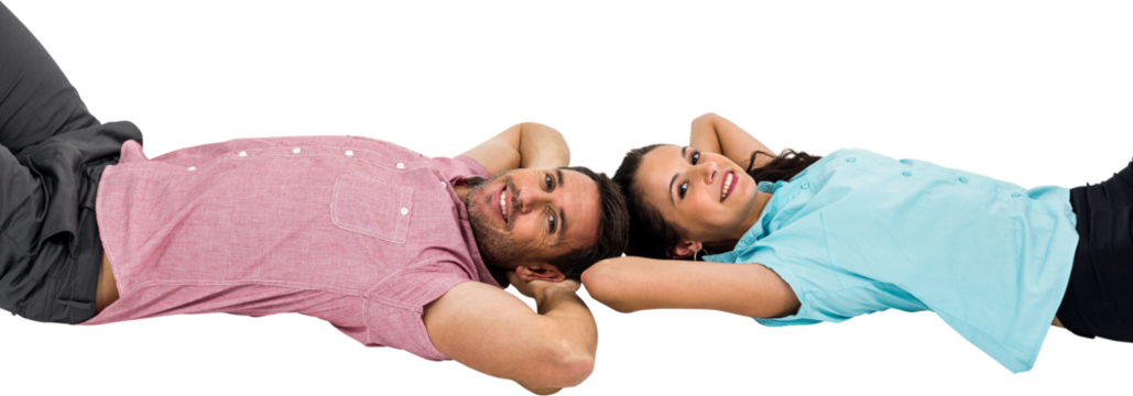 Smiling couple laying on floor with hands on their heads