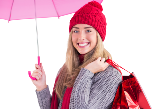 Festive blonde holding umbrella and bags