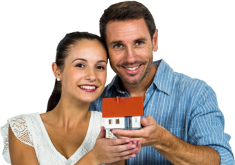 Excited couple holding house model