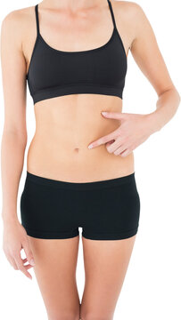 Closeup mid section of a fit woman with hand on stomach