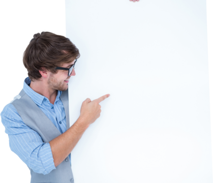 Smiling handsome man pointing at billboard