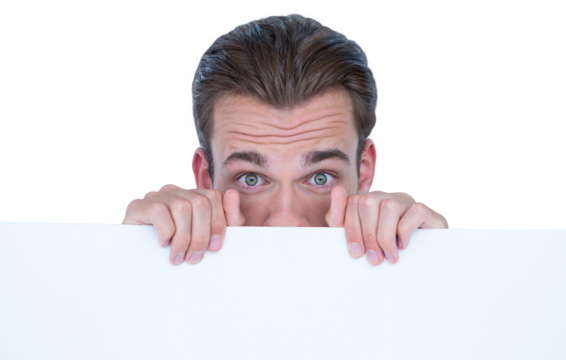 Portrait of man hiding behind billboard