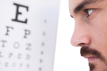 Focused man on eye test letters