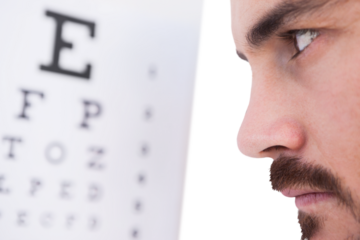 Focused man on eye test letters