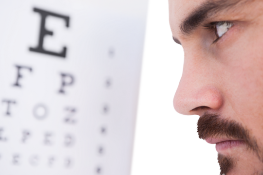 Focused man on eye test letters