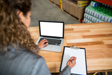 Businesswoman writing report 