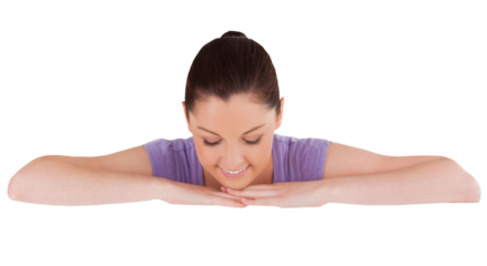 Beautiful woman posing behind a billboard while standing