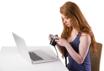 Pretty redhead working on laptop