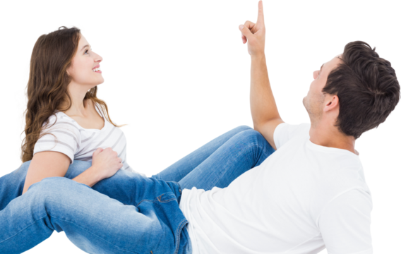 Happy couple lying on floor and pointing up