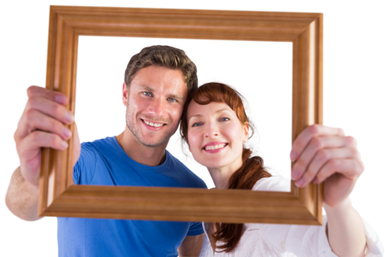 Couple holding frame ahead of them